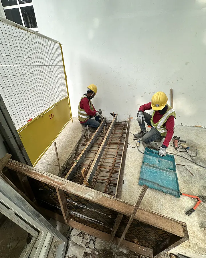 Reinforced concrete footing being prepared beside the Temasek Shophouse wall